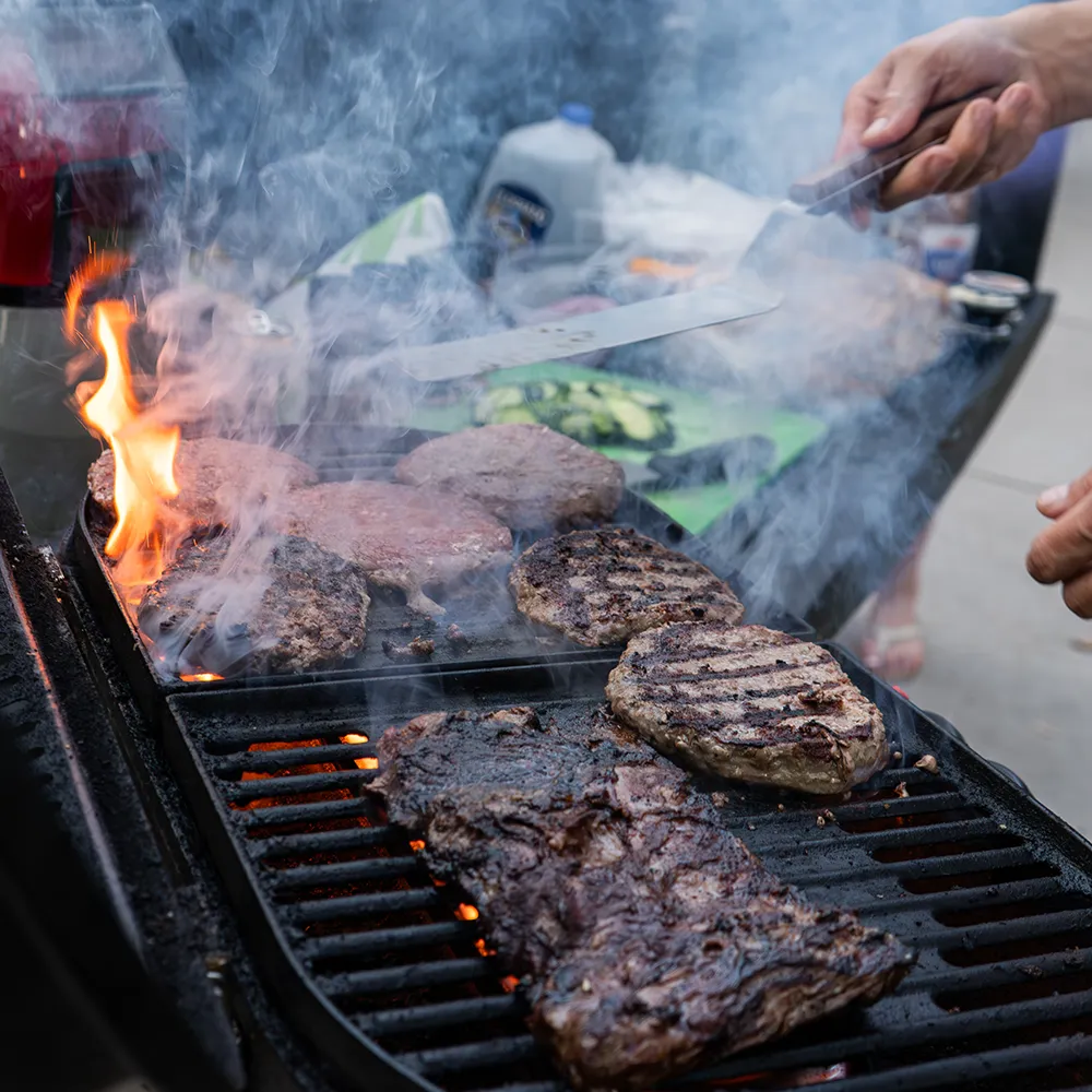 Centennial Cuts Centennial Cuts Premium Tailgater bundle showing marinated skirt steak burgers grilling